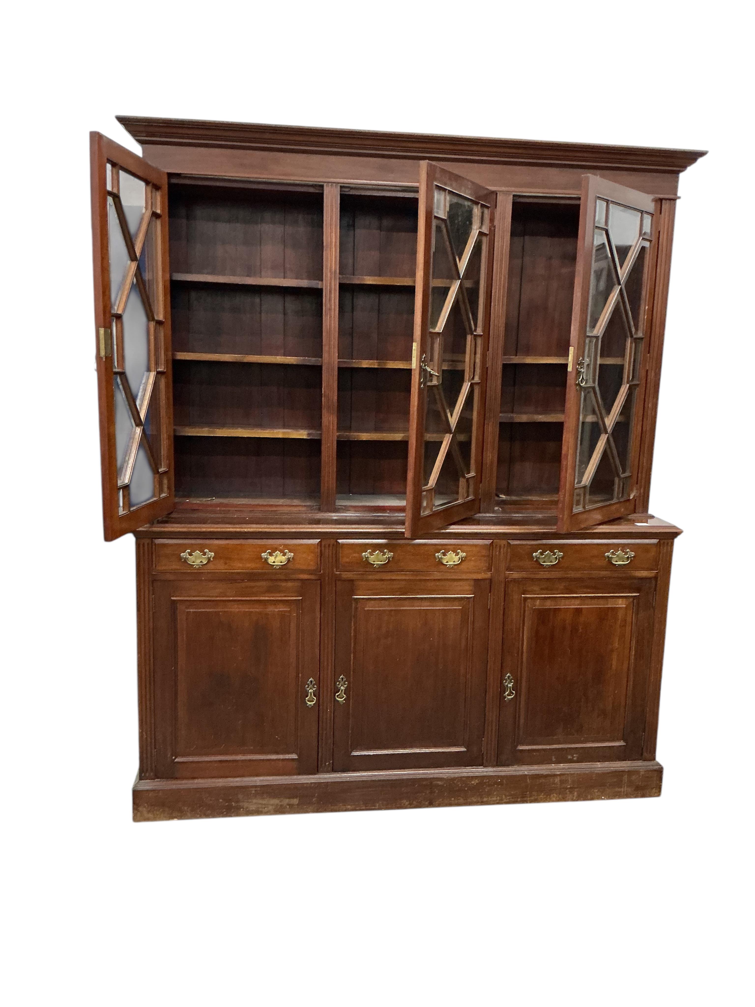 A late Victorian mahogany library bookcase with glazed upper section, width 184cm, depth 46cm, height 222cm